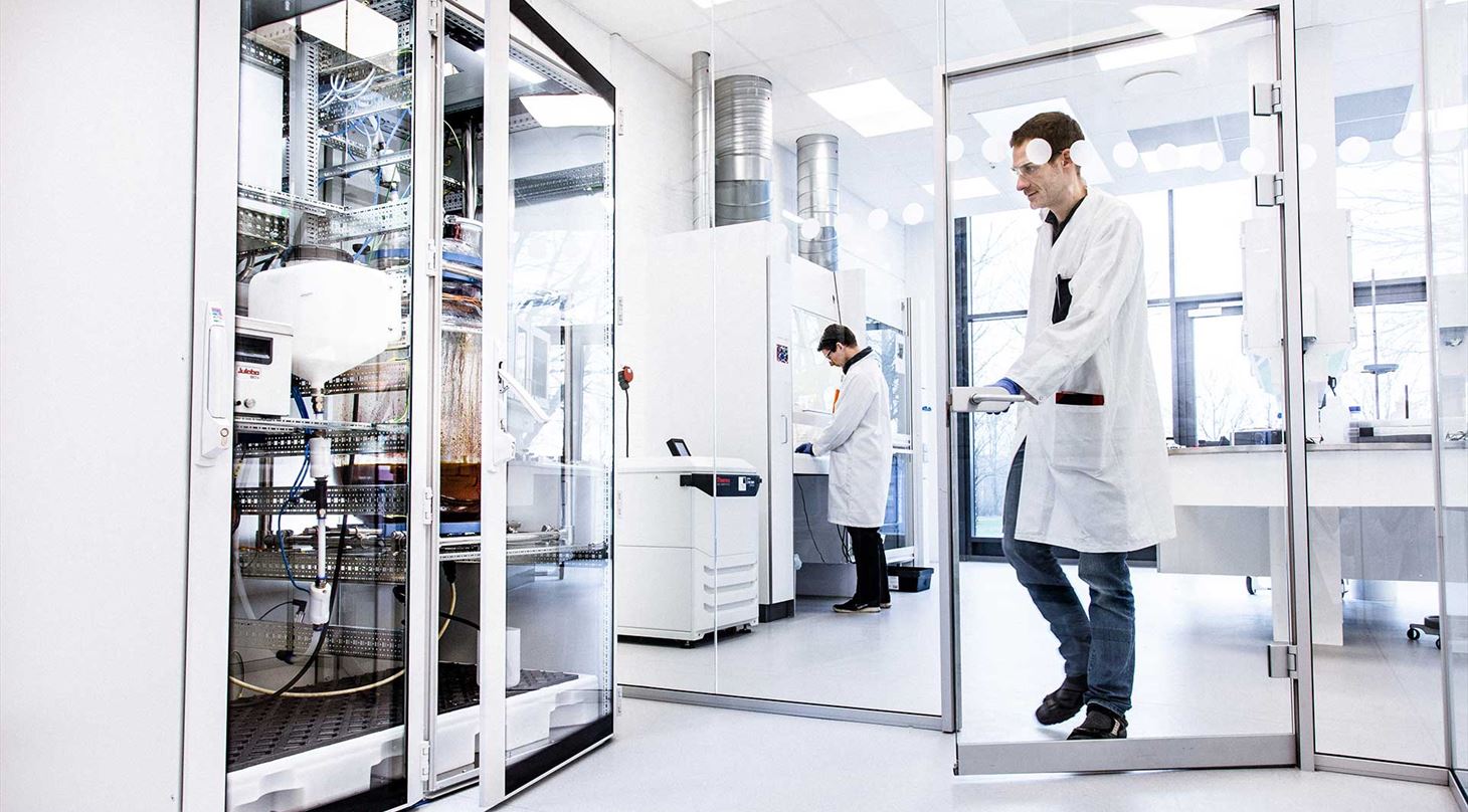 Scientist in laboratory with a copper reactor