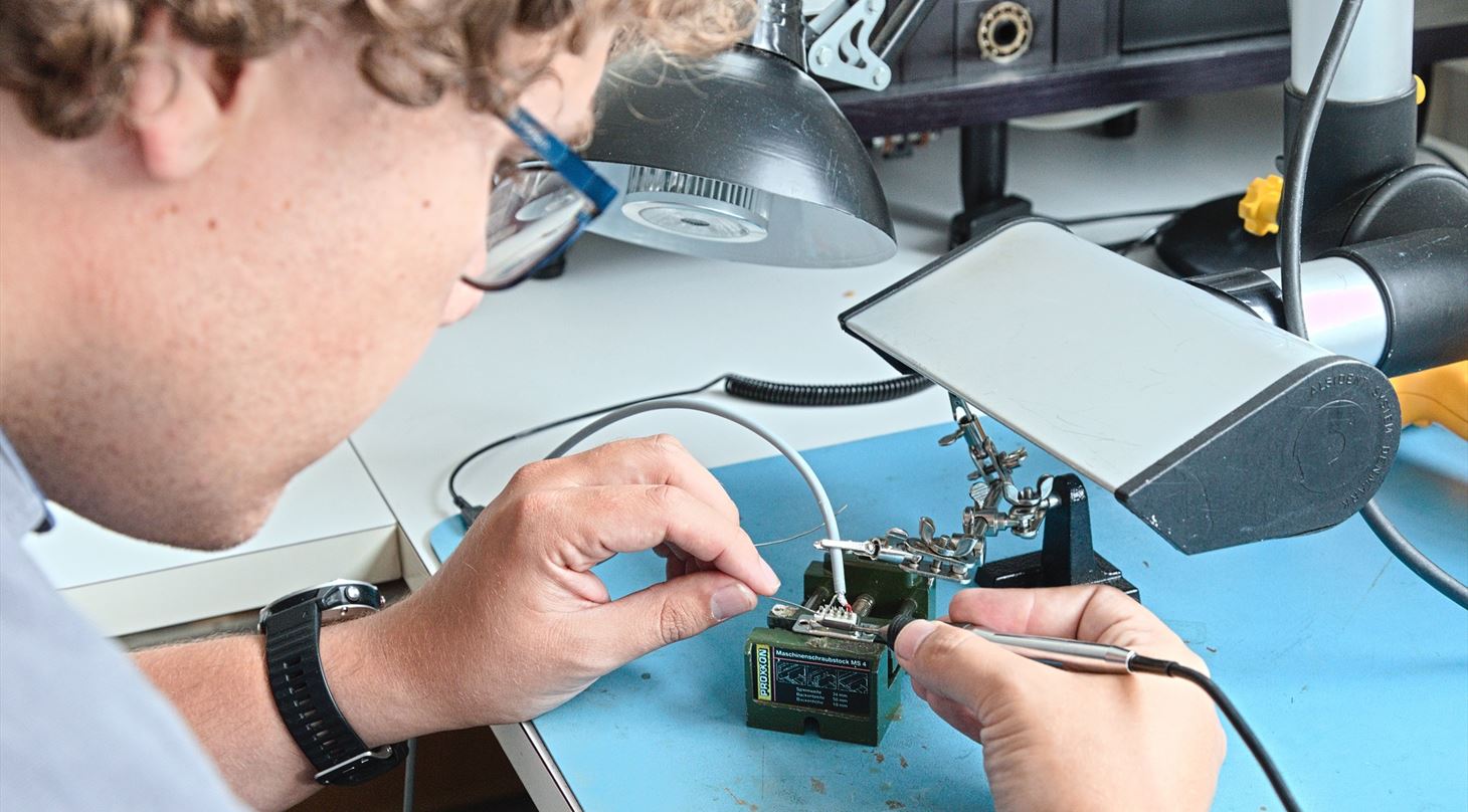 Employee soldering electronics