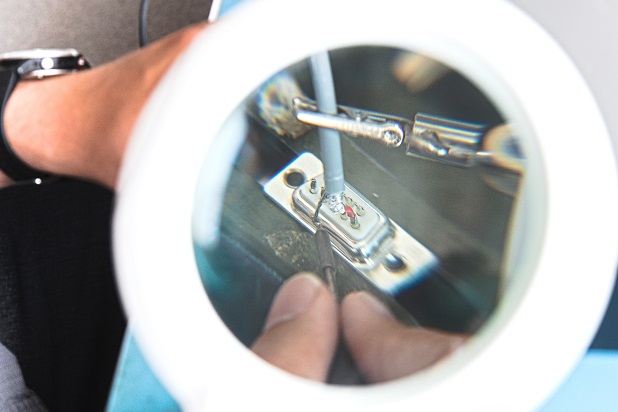 A close up of electronics being soldered by an engineer