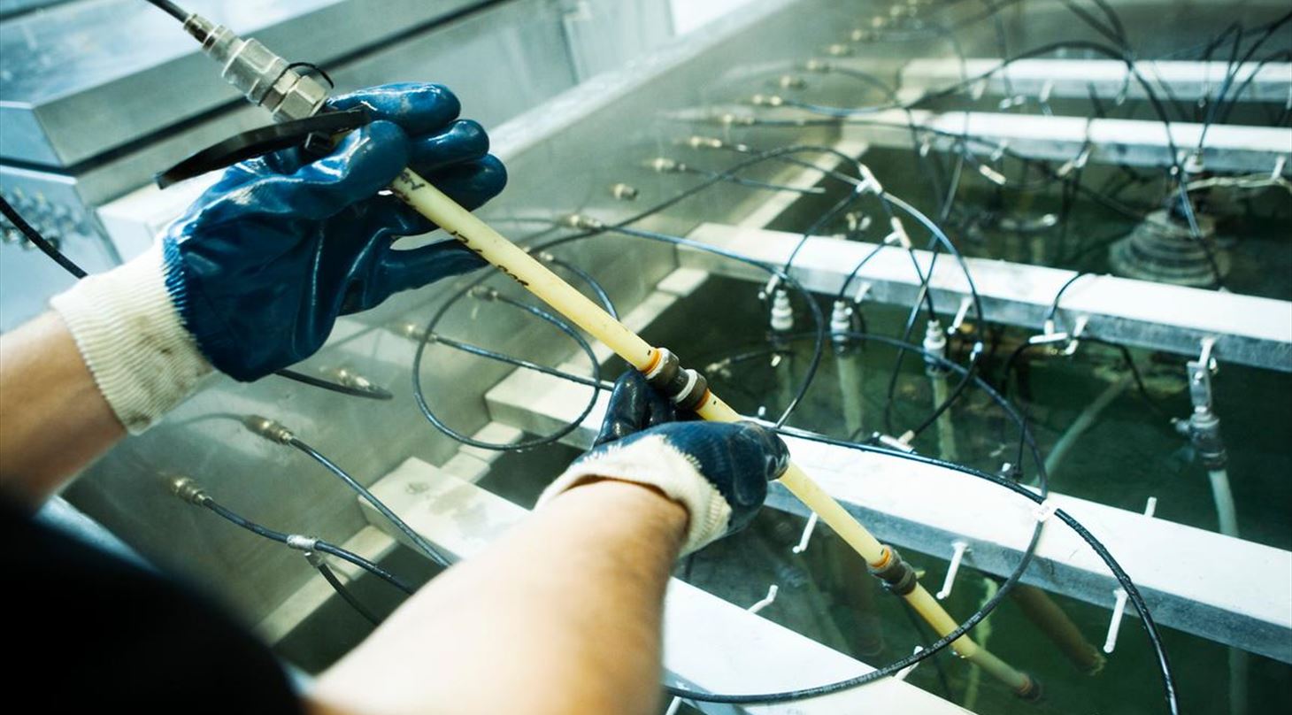 Picture of hands handling af piping system in water